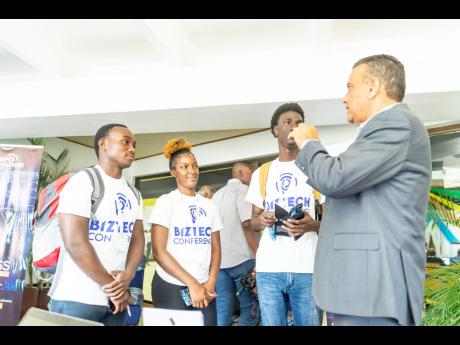 Stephen Juteram (right), vice president of Hitachi, with BizTech volunteers.