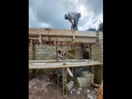 Foreman Audley Dennie and Johnoy Dennie resume work on a two-storey residential structure in Stony Hill, St Andrew, after Monday’s earthquake.
