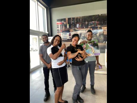 The BMW and MINI service team are all smiles holding their German Shepherd puppies while they showcase their True Pet posters and True Pet goodie bags for their pets.