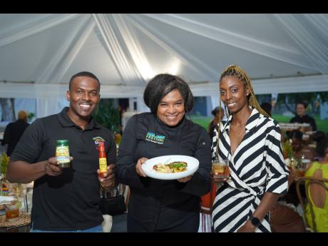 Walkerswood’s trade supervisor, Girvan Moore (left), Chef Jacqui Tyson (centre) and marketing manager, Tamika West, are all smiles at the JF&D Worthy Experience alfresco dining. 