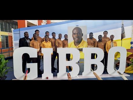 Students at G.C. Foster College of Physical Education and Sport display a photo of Gibbs Willams along with the letters GIBBO, which he was affectionately called, during a memorial service at the institute based in Angels, St Catherine, on Wednesday.