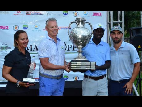 American Andrew Arft (right ) poses along with his caddie Jason Richards (second right) and sponsor Scott Summy (second left) of Aqua Bay along with President of the Jamaica Golf Association Jodi Munn-Barrow at the presentation ceremony of the 56th Jamaica