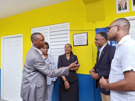 From left: Clayton Smith, principal of Grange Hill Primary, discussing the importance of removing his school fron the shift system with Dr Michele Pinnock, director, Region 4, Ministry of Education and Youth; Marsha Smith, state minister in the Ministry of