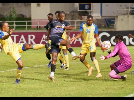 Jalmaro Calvin (centre) scores Cavalier’s second goal in the first leg of the Concacaf Caribbean Cup semi-final between Cavalier and Harbour View on October 24 at Sabina Park. 