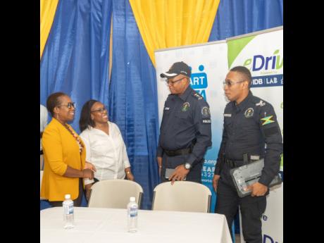  Project eDrive x JCF.  Specially invited guests SSP Aaron Fletcher (second right) and Corporal Raphael Hudson (right) are greeted by JPS Corporate Communications Director, Winsome Callum and Project eDrive, Project Manager, Coleen Palmer-Wright during the
