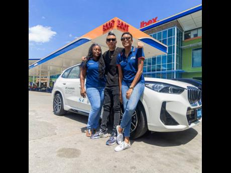 JPS Content Specialist Jhenelle Lewis (left), Nick Lue (centre), and Project eDrive Project Assistant Roshell Masters exude road trip vibes as the eDrive Myth-Busting North Coast Tour made its first pit stop at Boot Service station in St Ann on August 30.