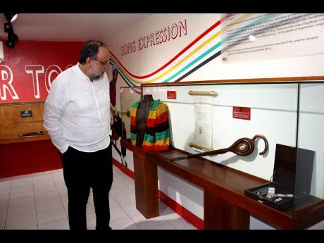 Opposition Leader Mark Golding observes the  of the new artefact, the Order of the Companions Of O.R. Tambo in Silver, at the Peter Tosh Museum, Pulse Center, 38A Trafalgar Road, New Kingston.