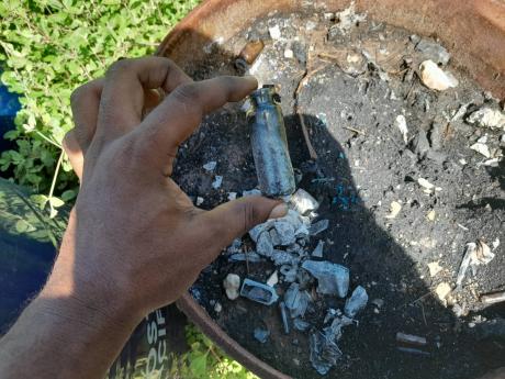 Inside the drums, there were small glass vials, and charred packets of tablets.