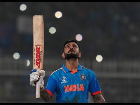 India’s Virat Kohli looks skywards as he celebrates scoring a century during the ICC Men’s Cricket World Cup match between India and South Africa in Kolkata, India, yesterday.