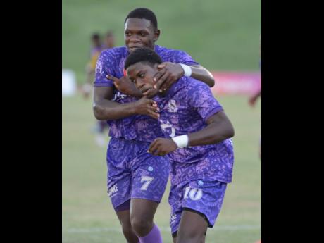 Jaheim McLean (right) celebrates with Kingston College teammate Kimani Reece after scoring the lone goal of an ISSA/Digicel Manning Cup quarter-final round football game against St Andrew Techical High School atthe Stadium East field yesterday.