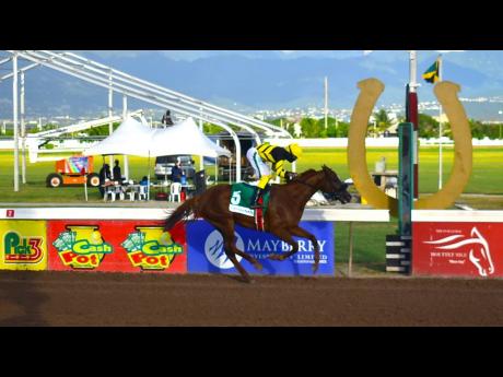 ATOMICA, ridden by Robert Halledeen, wins the Jamaica Cup over nine and a half furlongs, a graded stakes for horses, three years old and upwards at Caymanas Park yesterday.