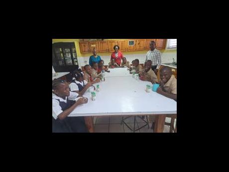 Joni Tucker (centre), principal of Linstead Primary School, with a group of her students and the St Catherine school’s guidance counsellors.