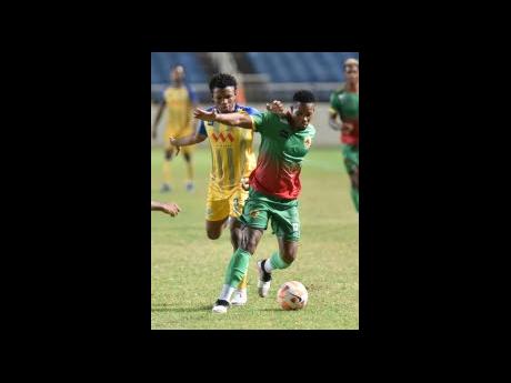 Okeemo Jones (left) of Harbour View tackles Humble Lion’s Andrew Vanzie during their Wray and Nephew-sponsored Jamaica Premier League match at Sabina Park yesterday. The match ended in a 2-2 draw. 