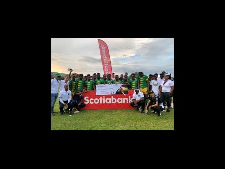 Members of the St Elizabeth-based Treasure Beach Football Club pose with a symbolic cheque for $1 million, which they received from Scotiabank in support of the team’s participation in the 2023 Wray and Nephew Jamaica Premier League football competition 