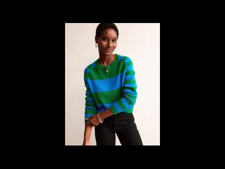 The SAINT model is dressed in a merino jumper in cobalt and green hues.