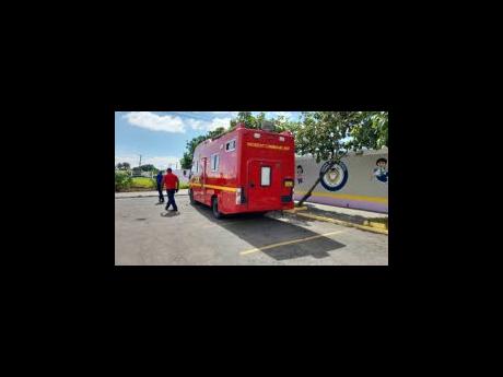 An Incident Command Unit positioned outside Greater Portmore High School after the report of security threats at the school. 