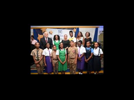 Parris A. Lyew-Ayee (back row, left), chairman of the JN Foundation; Claudine Allen (back row, third left), general manager of JN Foundation; Delories Jones (back row, second right), senior vice-president, sales; and Rose Miller, JN Foundation’s manager 