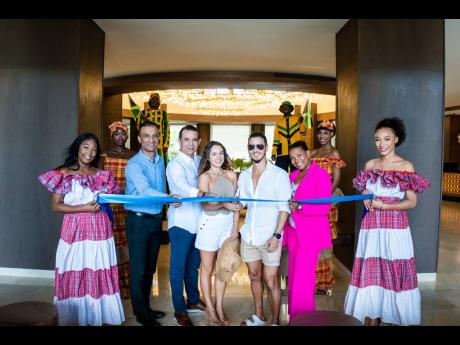 Carlos Estrada (second left), general manager, Hideaway at Royalton Blue Waters, and Guarav Sindhi (third left), regional vice president, operations, cuts the ribbon officially opening the hotel with Kerry-Ann Quallo-Casserly (second right, pink suit),regi