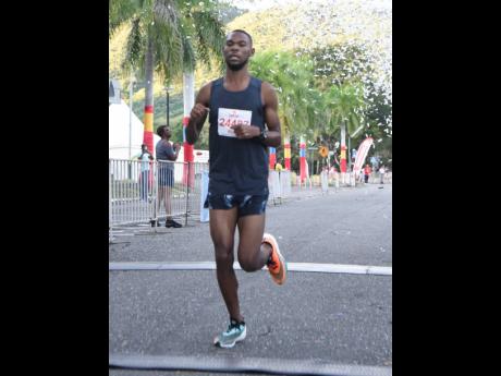 Garfield Gordon wins the CB Group/UWI 5K at the University of the West Indies, Mona yesterday.
