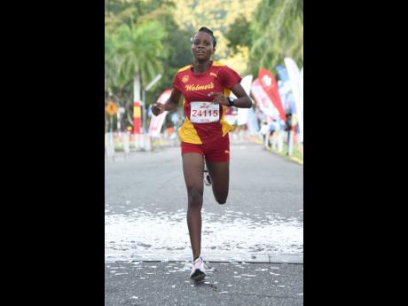 Janeail Henry of Wolmer’s Girls wins the female category at the CB Group/UWI 5K  at the University of the West Indies, Mona yesterday.