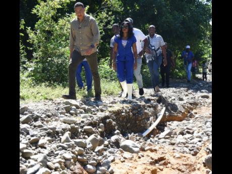 Ian Allen
 Prime Minister Andrew Holness (left), Dr. Michelle Charles (2nd left), Member of Parliament, St. Thomas, Eastern, look at what is left of Morgan’s Lane in Cheswick after water from recent heavy rains washed away the asphalt and turned the road