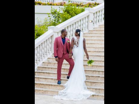 The lovely couple share a beautiful moment standing on the stairway, united in love.