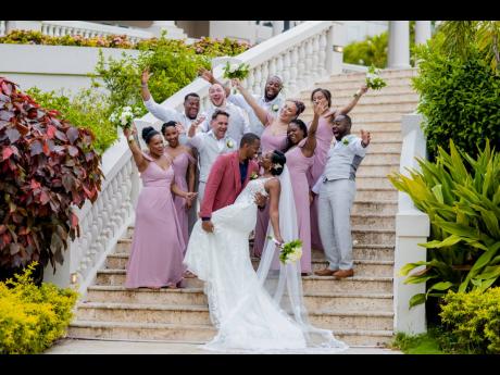 In the embrace of their adoring bridal party, Jermaine and Kayla Latham share a perfect moment.