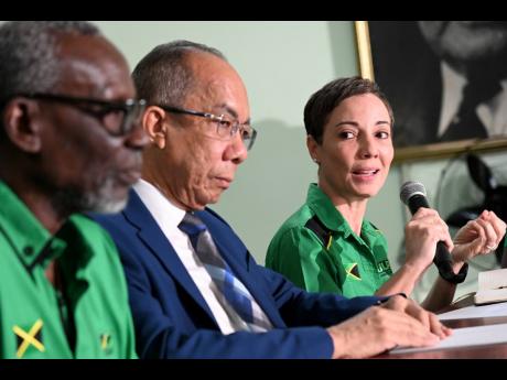 Jamaica Labour Party (JLP) Senator Kamina Johnson Smith addresses journalists during a press conference on Tuesday to launch the party’s 80th anniversary conference. Looking on are Conference Chairman Desmond McKenzie and JLP General Secretary Dr Horace 
