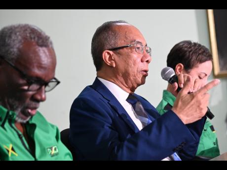 JLP General Secretary Dr Horace Chang makes a point during Tuesday's press conference. He is flanked by Desmond McKenzie (left) and Kamina Johnson Smith.