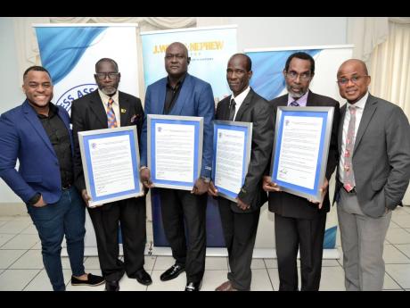 Garfene Grandison (left), corporate communications manager at J. Wray and Nephew and guest speaker, with George Davis (right), past president of the Press Association of Jamaica (PAJ), and honourees (from second left) Everard Owen, Kirk Hall, Aires Fagan a