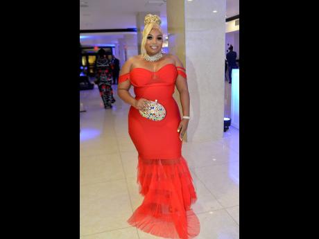 Shelicia Stephenson-Stewart looks absolutely stunning in a jaw-dropping red mermaid-cut dress that showcases a captivating sweetheart neckline.