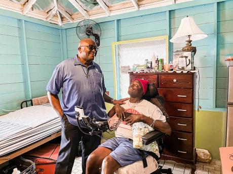 Father Augustine Garvin, executive Priest of the Mustard Seed Communities International (left), visits Jacob’s Ladder resident, Lincoln in his new semi-independent living home. 