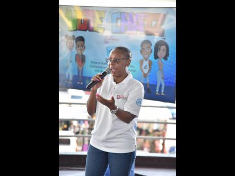 Nickeisha Barnes, director of health promotions and prevention at the National Family Planning Board, gives an overview of the Yute Chatz bot at the launch of the service at the Half-Way Tree Transport Centre on Friday.