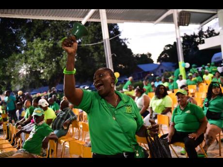 A Jamaica Labour Party (JLP) member rings a bell at Lodge Hall for the JLP Area Council One Meeting, Central Kingston.