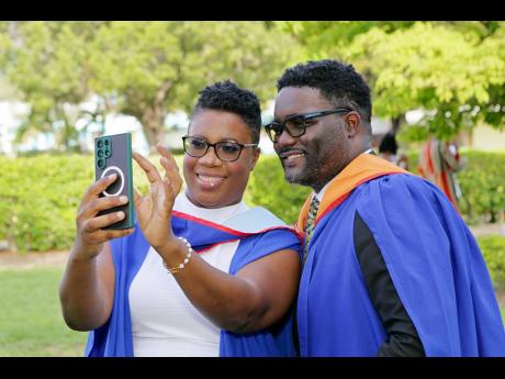 The Millers take a selfie as they celebrate achieving their master’s degrees together.