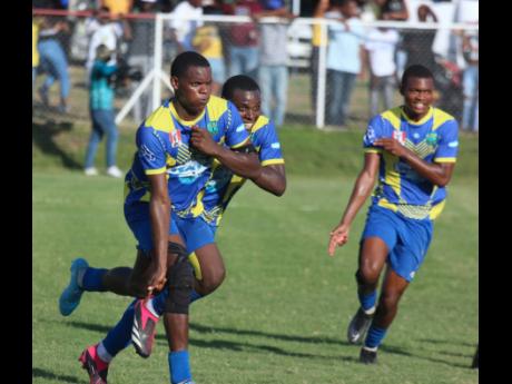 Photo by Lenox Aldred 
Clarendon College captain and man of the match, Malachi Douglas (left), celebrates with teammates after scoring the opening goal against Garvey Maceo in their ISSA/WATA daCosta Cup semi-final encounter at Glenmuir High School on Satu