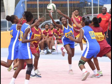 St Hugh’s High School’s Kayama Brown (centre), intercepts a pass during a second-round Urban ISSA Schoolgirl Netball match against Wolmer’s Girls at the Leila Robinson Courts on November 15.