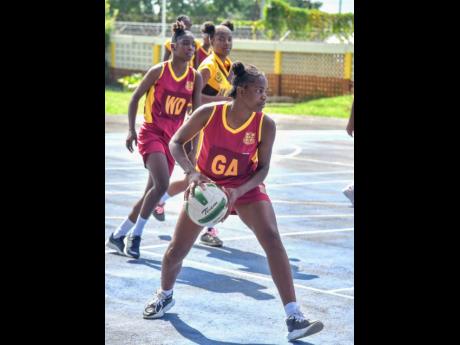 Holmwood High School’s Jada Ricketts looks to pass during a Rural ISSA Schoolgirl Netball game against Manchester High School at the GC Foster College on Monday. 