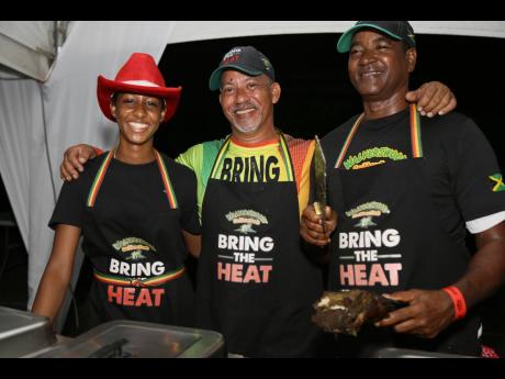 The Sheriff himself, David Bucknor of Sheriff Gourmet Ja, is sandwiched between Naomi Blake and Wayne King, showcasing the curried jerk pork.