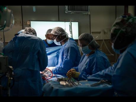 Gladstone Taylor/Multimedia Photo Editor
A team of doctors perform what was described as the first ever  anomalous left coronary artery from the pulmonary artery (ALCAPA) surgery at the Bustamante Hospital for Children in St Andrew, yesterday. 