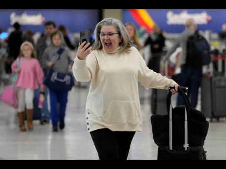 Marissa Colleluori talks to her granddaughter through FaceTime at the Nashville International Airport, Tuesday, November 21, 2023, in Nashville, Tenn, before boarding her flight to Buffalo for the Thanksgiving holiday.  