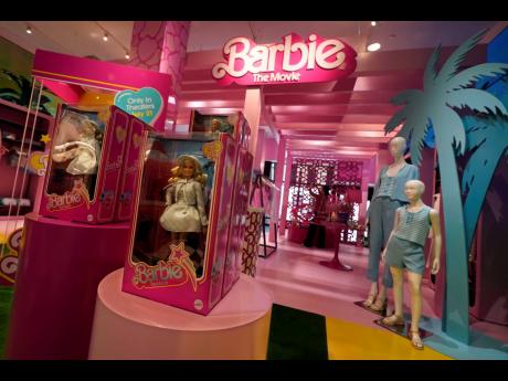 Barbie-themed merchandise is displayed in a special section at Bloomingdale’s, in New York, Thursday, July 20. The ‘Barbie’ movie, parent company, Mattel, created a product marketing blitz with more than 100 brands plastering pink everywhere. 