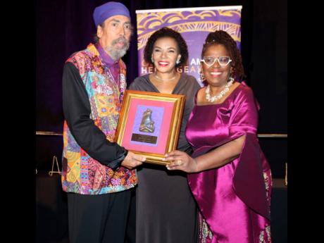 Jamaica’s Ambassador to the United States, Audrey Marks presents  Stephen (Cat) Coore with the Caribbean-American Heritage Luminary Award at the 30th Caribbean-American Heritage Awards ceremony at the JW Marriott Hotel in Washington DC, on November 18. A