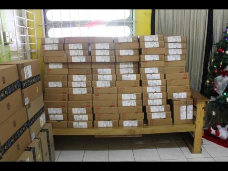 Some of the laptops donated by Food For The Poor Jamaica to be given as gifts to children attending the Windsor Scool of Special Education.