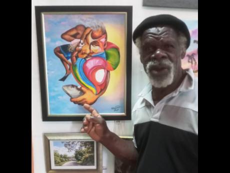 Artist Bunny Hewitt with one of his paintings.