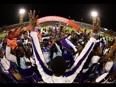 Students and athletes from Kingston College celebrate their title victory at the Champs.