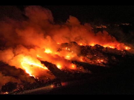 Fire consumes an area next to the Transpantaneira road in the Pantanal wetlands near Pocone, Mato Grosso state in Brazil.