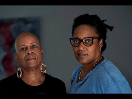 Gloria Webster (left), and her daughter Angelique Webster, of Worcester, Mass., an independent filmmaker, stand together for a photograph, Thursday, Sept. 7, 2023, at Angelique’s home, in Worcester, Mass. Angelique was abused by their parish priest. Glor