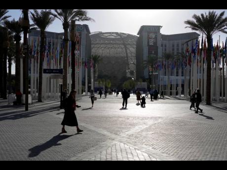 
People walk through the venue at the COP28 UN Climate Summit near the Al Wasl Dome at Expo City, Thursday, November. 30, 2023, in Dubai, United Arab Emirates.