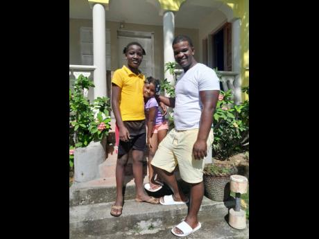 11-year-old Fytzroi Robinson with his six-year-old sister Quirina Robinson and father, Fitzroy Robinson